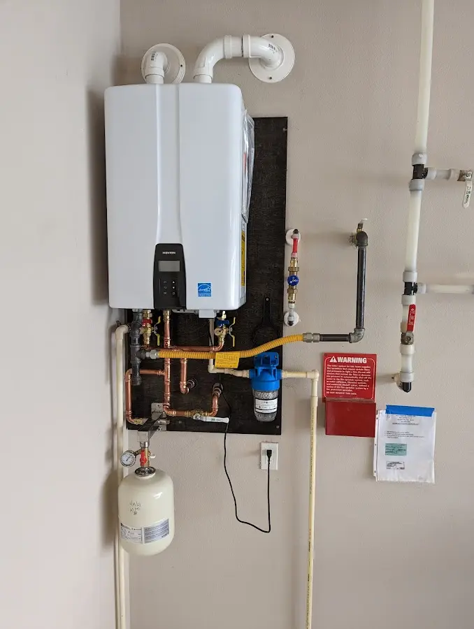 Professional plumber installing copper piping in a Feather Sound home